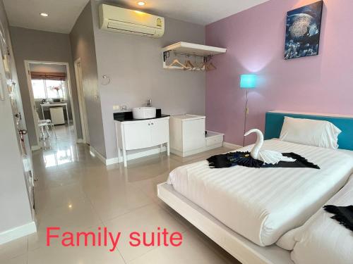 a bedroom with a large bed with a swan on it at Thalassa Kata Beach in Kata Beach