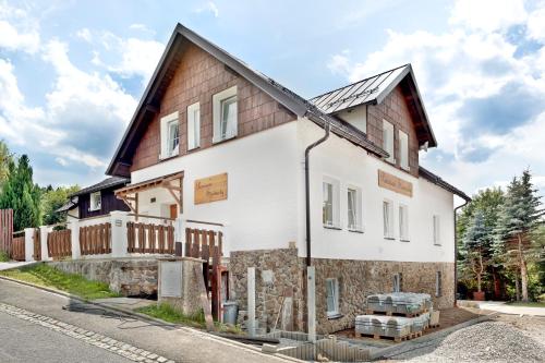 a house being built on the side of a street at Penzion Samoty in Železná Ruda