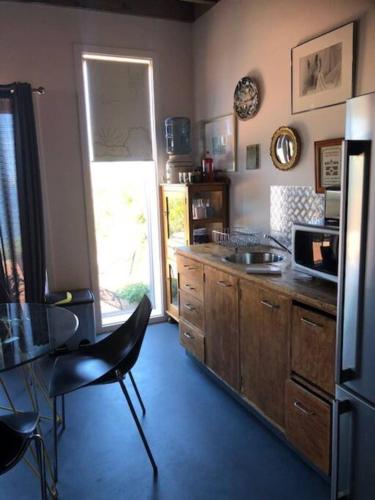 a kitchen with a counter and a sink and a refrigerator at H&H studio overlooking Boston Bay, Port Lincoln in Port Lincoln