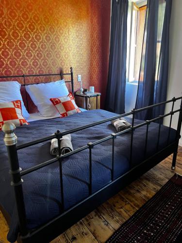 sypialnia z łóżkiem z niebieską pościelą i pomarańczowymi ścianami w obiekcie CASA LINDNER Villa Rustico Ferienhaus 400m zum Gardasee 13Schlafplätze w mieście Toscolano Maderno