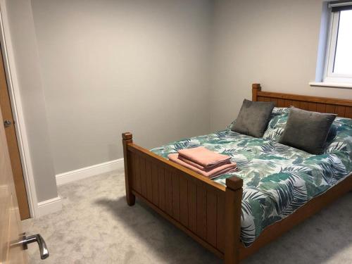 a bed with two pillows on it in a room at New ground floor 2 bed flat close to the beach in Southbourne