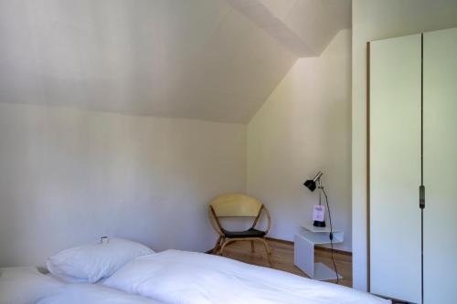 a bedroom with a bed and a chair in it at Villa Pineta in Fusio