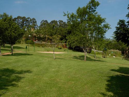 a park with trees and a swing set in the grass at Penny's Place on Greenway in White River