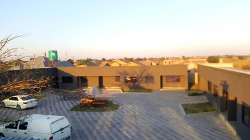 a van parked in a parking lot next to a building at LEGENDS EXECUTIVE LODGE in Choma