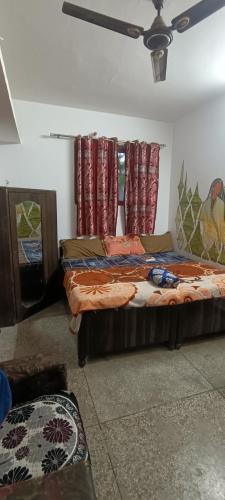 a bedroom with two beds and a window with curtains at BlaBla House Rishikesh in Rishīkesh