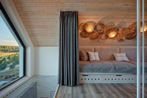 a room with a bed with logs on the wall at Osada Stara Rzeka in Stara Rzeka