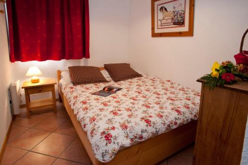 a bedroom with a bed with a laptop on it at le signal 105 apartment in residence 50 meters from slopes 4-6 people in Montalbert