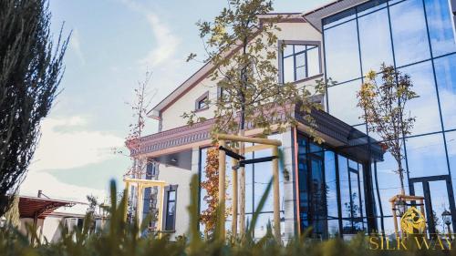 a rendering of a building with glass windows at Boutique Hotel Silk Way in Türkistan