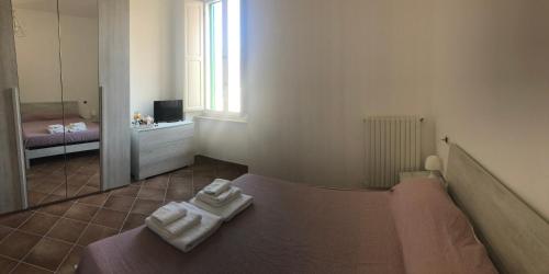 una camera da letto con un letto e due asciugamani di A casa di Noemi a L'Aquila