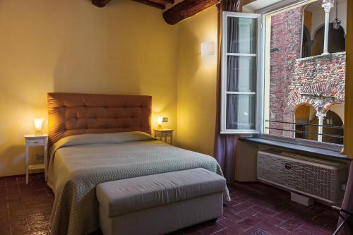 a bedroom with a bed and a window at Antica Residenza Dell'Angelo in Lucca