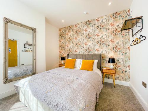 a bedroom with a bed and a large mirror at Ashfield Boutique Stays in Altrincham
