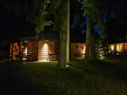 a log cabin at night with two trees at Siedlisko nad Jeziorem-Mazury in Mrągowo