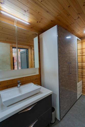 a bathroom with a sink and a shower at SaffronStays Paradise Pines, Dehradun - cliff villa with valley & forest views in Dehradun