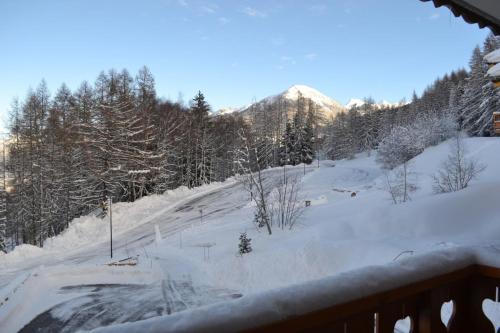 a snow covered slope with a mountain in the background at Chalet de Montalbert 22B in Montalbert