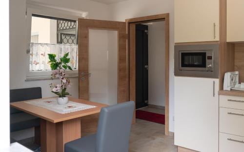 a small kitchen with a table and a microwave at Ferienwohnung mit Salzachblick in Laufen