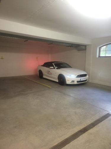 a white car parked in a parking garage at Kamzik Apartment hill view with garage in Donovaly