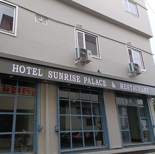 a hotel sunrise palace and restaurant sign on a building at Hotel Sunrise Palace in Udaipur