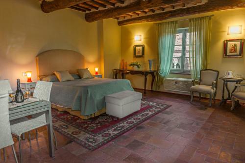 a bedroom with a bed and a table and chairs at Antica Residenza Dell'Angelo in Lucca