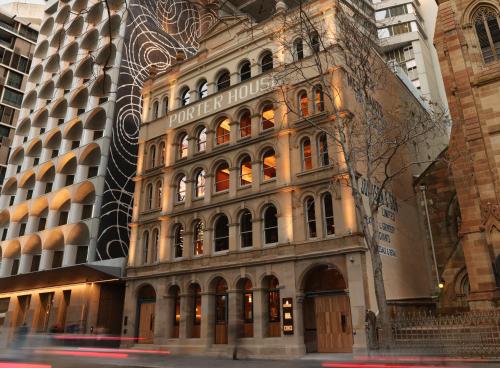 a building on the corner of a street with buildings at The Porter House Hotel Sydney - MGallery in Sydney