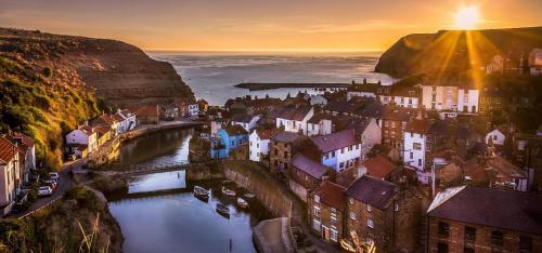 a city with a bridge over a river with buildings at 6 Guests - Bell Tent - Wood Stove - Views in Liverton
