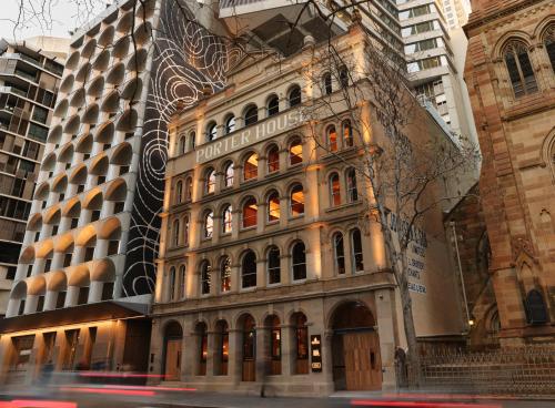 a building on the corner of a city street at The Porter House Hotel Sydney - MGallery in Sydney