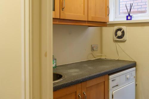 a kitchen with a sink and a counter top at Stylish family home in desirable Penylan + Parking in Cardiff