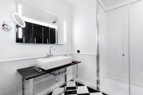 a bathroom with a sink and a shower at Grotthuss Boutique Hotel Vilnius in Vilnius