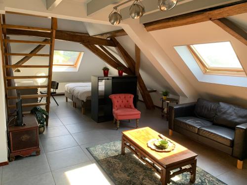 a living room with a loft bed and a couch at 't Brouwershuis in Leende