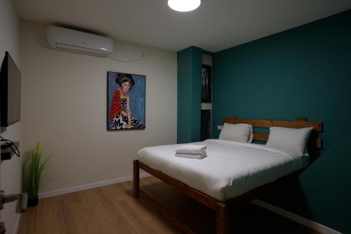a bedroom with a bed and a painting on the wall at RAKEFET - Traveler's House - EILAT in Eilat