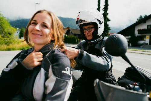 a man and a woman on a motorcycle at Hotel Gailtaler Hof in Kötschach