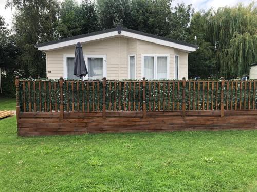 a wooden fence in front of a house at St Andrew's Retreat in Tydd Saint Giles