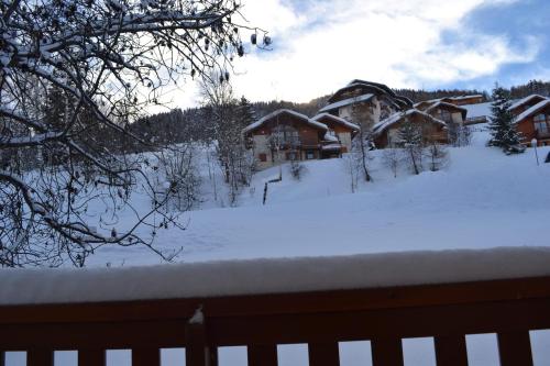 a yard covered in snow with a house at Signal 308 apartment 6 person in Aime-La Plagne