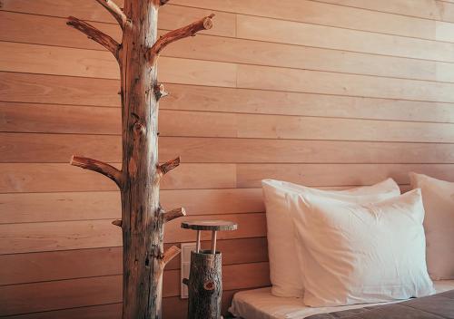 a bedroom with a tree next to a bed at Hotel AX in Helsinki