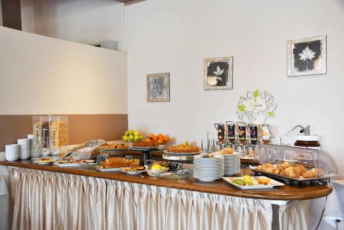 a buffet with many different types of food on it at Hotel Il Cervo, SPA & Wellness, Bike Hotel in Tarvisio