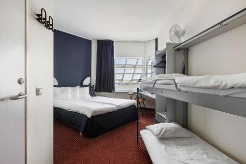 a small room with two beds and a window at Best Western Eurostop Orebro in Örebro