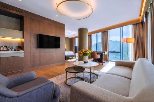 a living room with two couches and a tv at Radisson Collection Hotel, Vadistanbul in Istanbul