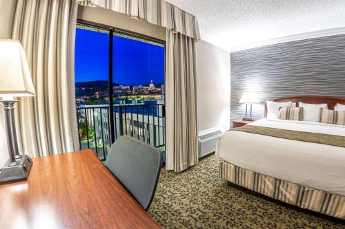 a hotel room with a bed and a large window at Salt Lake Plaza Hotel SureStay Collection by Best Western in Salt Lake City