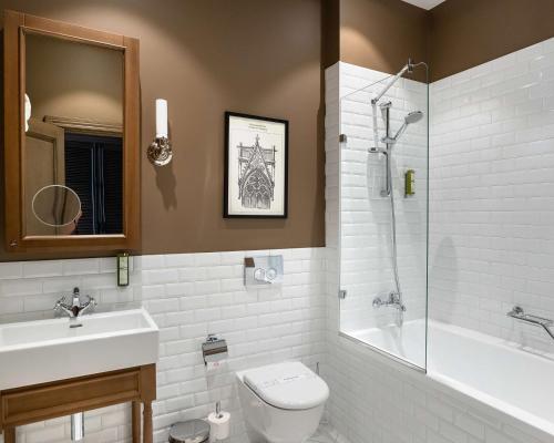 a bathroom with a toilet and a sink and a shower at Best Western Plus Market Square Lviv in Lviv