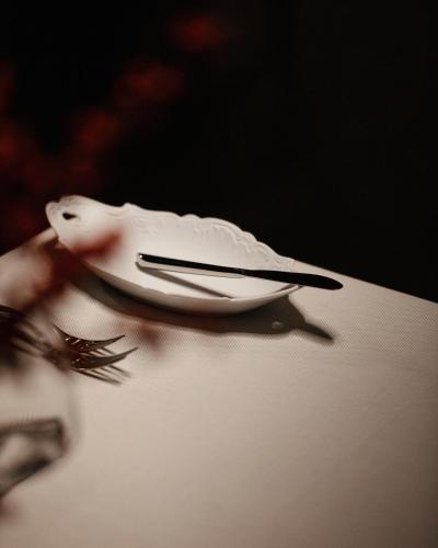 a white bird sitting on top of a table at Hotel Monopol in Katowice