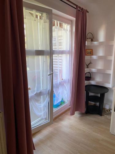 a room with a sliding glass door with a window at Apartament Raluca - self check-in in Timişoara