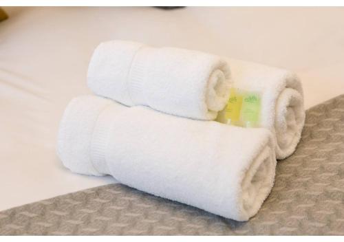 a stack of white towels sitting on a floor at ALTIDO Chic flat with balcony in Merchant City in Glasgow