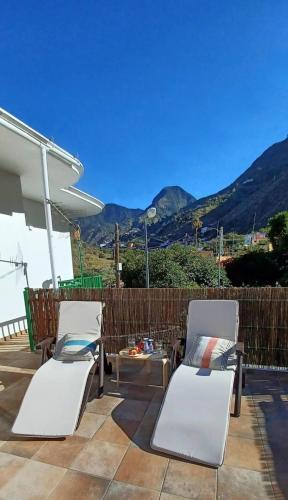 two white chairs and a table on a patio at Casa Efraim in Hermigua