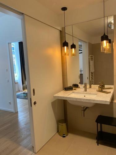 a bathroom with a sink and a mirror at Pure Berlin Apartments - Luxury at Pure Living in City Center in Berlin