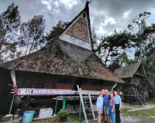 a group of people standing in front of a building at Nachelle Homestay in Berastagi