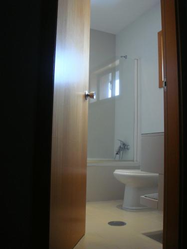 a bathroom with a toilet and a sink at Paredes Design Hotel in Paredes