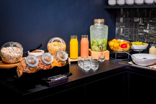 a table with a bunch of food and drinks on it at Tribe Paris La Defense Esplanade in Courbevoie