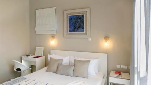a bedroom with a bed with white sheets and pillows at Royal Green Wellness Resort in Moka