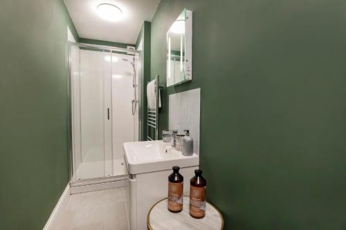 a bathroom with a toilet and a sink and a shower at 8 Blue Bridge- Elegant and Luxurious 1 Bedroom Apt- Free Parking in York