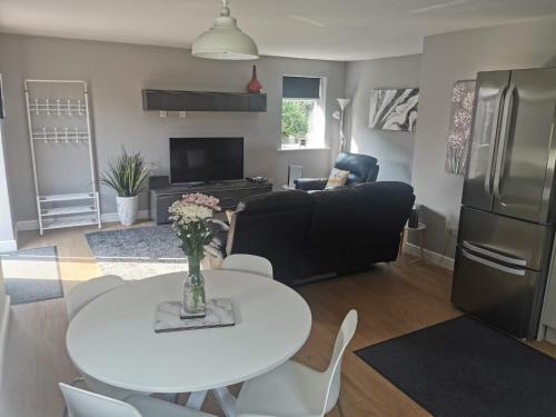 a living room with a white table and a couch at Green Street Retreat in York