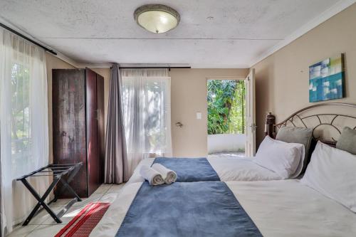 a bedroom with a large bed and a window at St Lucia Safari Lodge Holiday Home in St Lucia